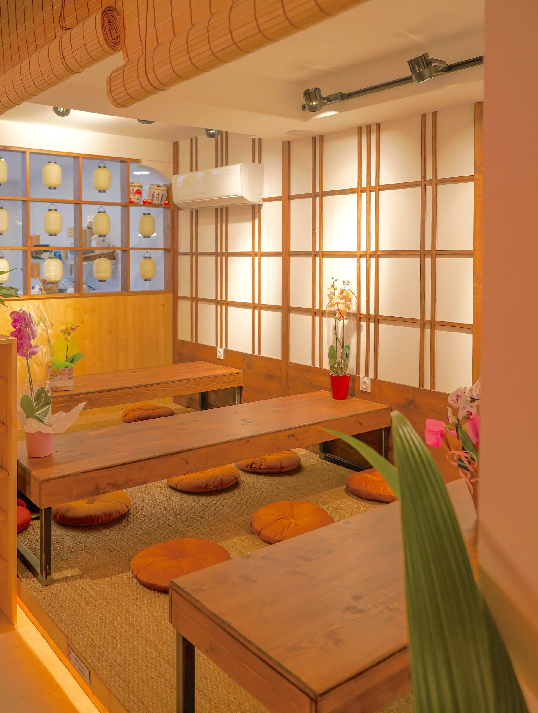 Le coin tatami : tables basses, coussins orange et cloisons shoji